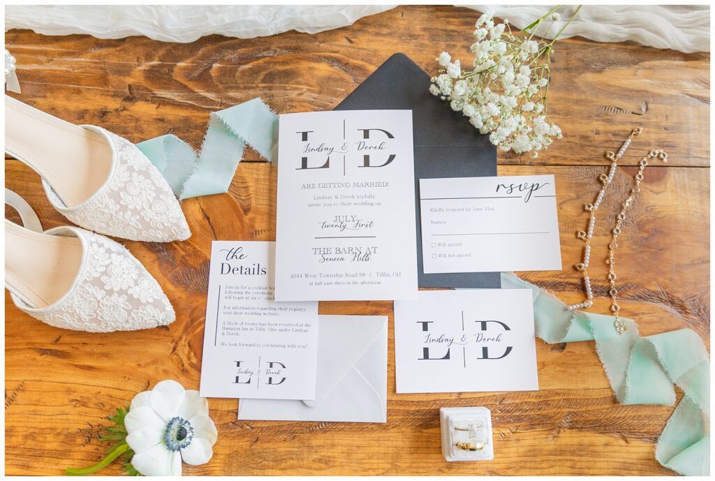 full wedding invitation suite with wedding shoes and baby breath and green ribbon