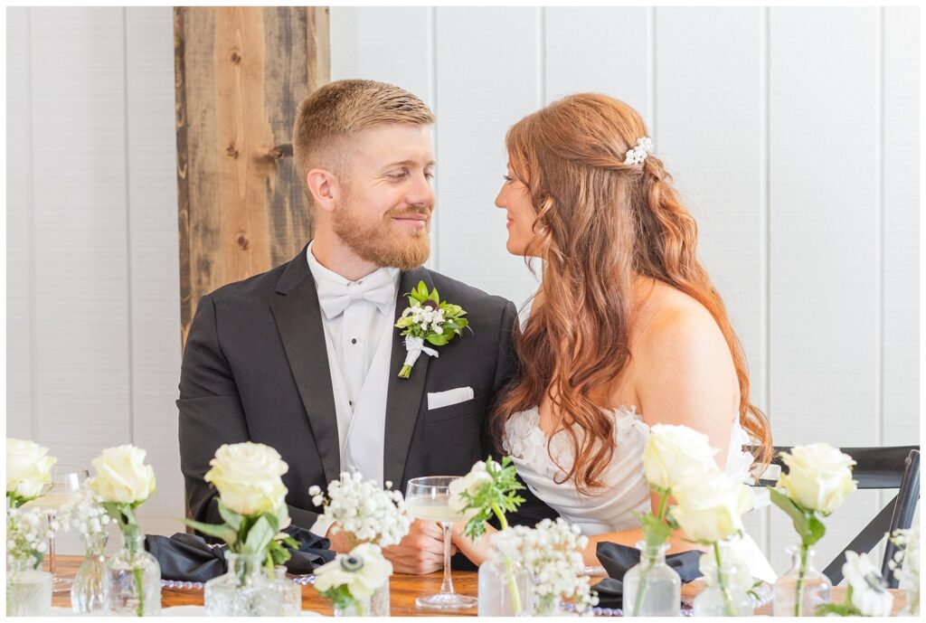 bride and groom together sitting at the reception table inside the venue in Tiffin, Ohio