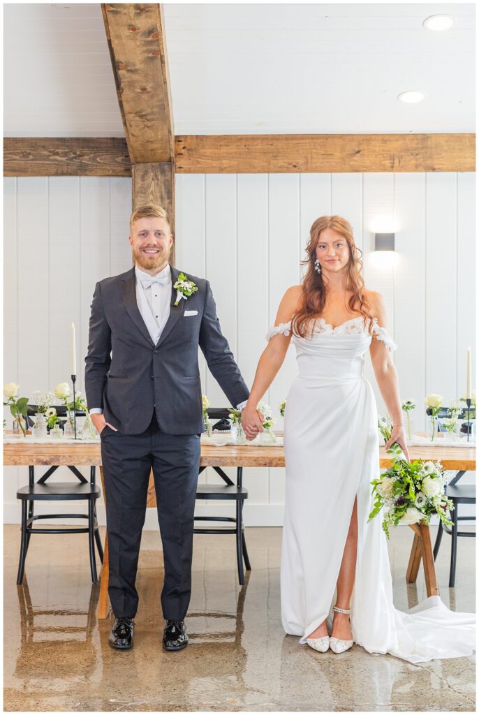 bride and groom holding hands in front of a reception table in Tiffin, Ohio