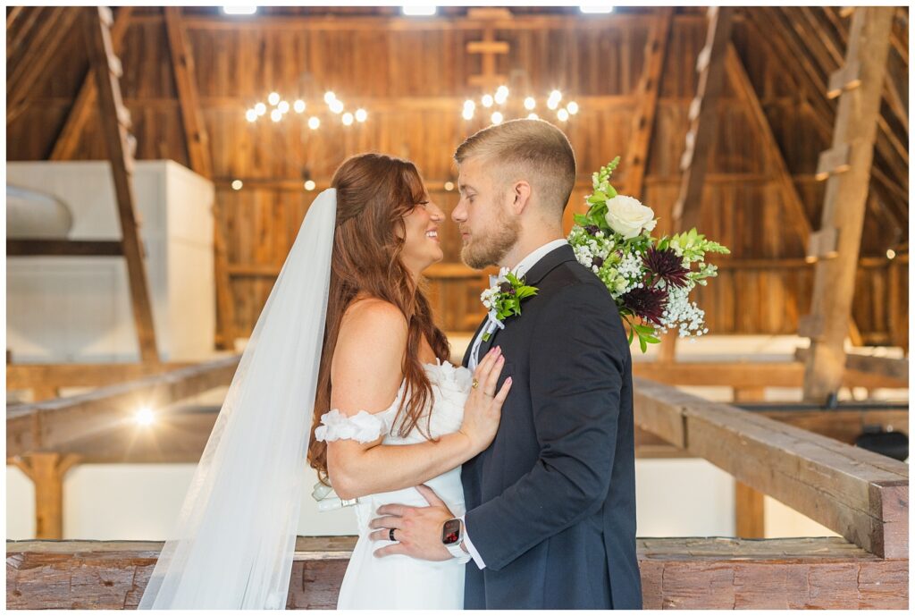 bride and groom posing on the balcony at The Barn at Seneca Hills venue