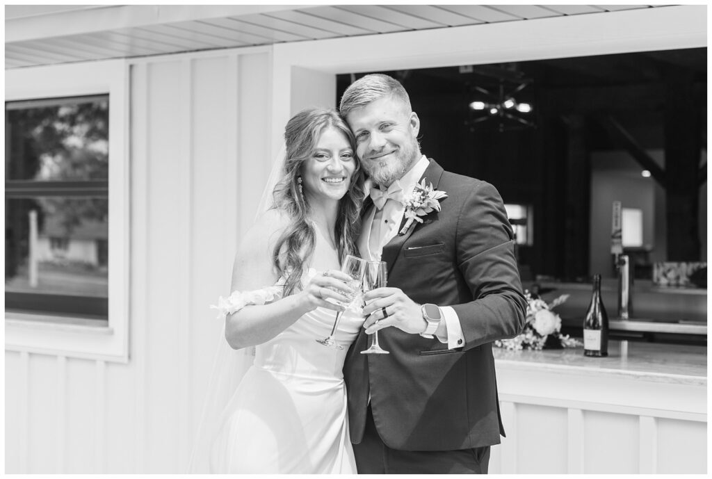 wedding couple toasting champagne flutes at the outside bar in Tiffin, Ohio