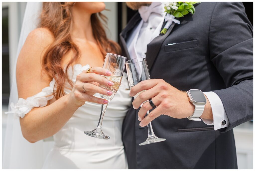 wedding couple toasting champagne flutes at the outside bar at Tiffin, Ohio venue