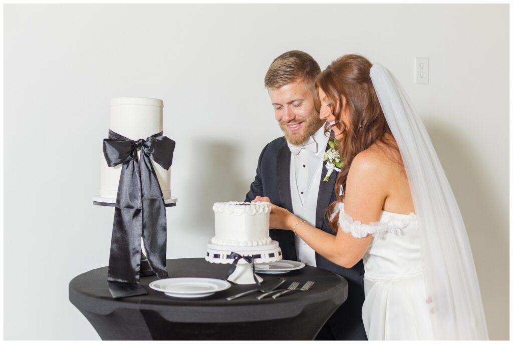 wedding couple cutting the cake at styled shoot at Tiffin, Ohio barn venue