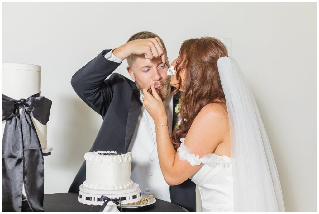 wedding couple cutting the cake at styled shoot at Tiffin, Ohio barn venue