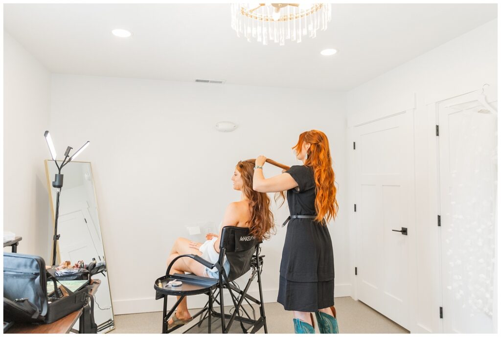 hair stylist fixing the bride's hair for the wedding styled shoot in Tiffin, Ohio