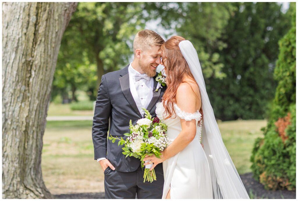 bride and groom posing on the patio outside at The Barn at Seneca Hills