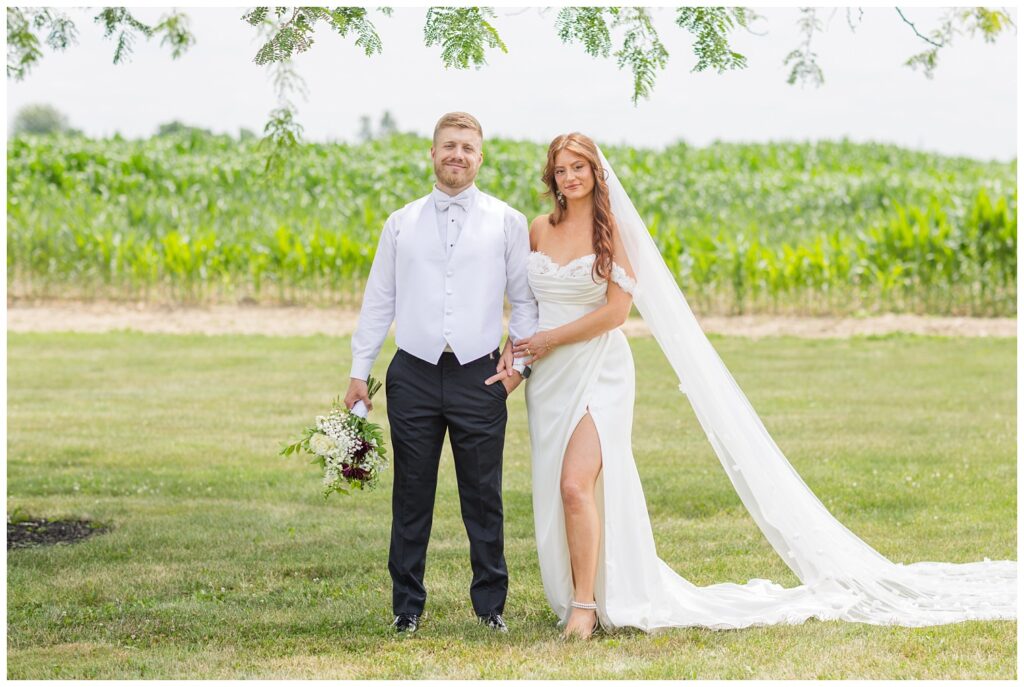 wedding couple holding hands outside at The Barn at Seneca Hills venue in Tiffin, Ohio