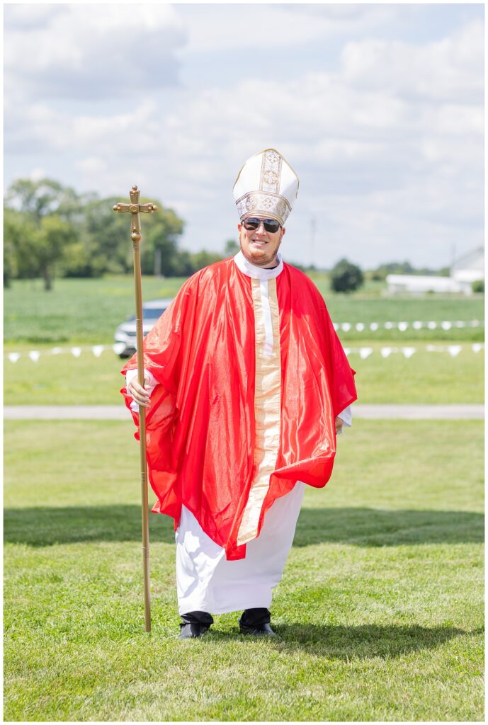 friend of the bride and groom dressed in a priest outfit 