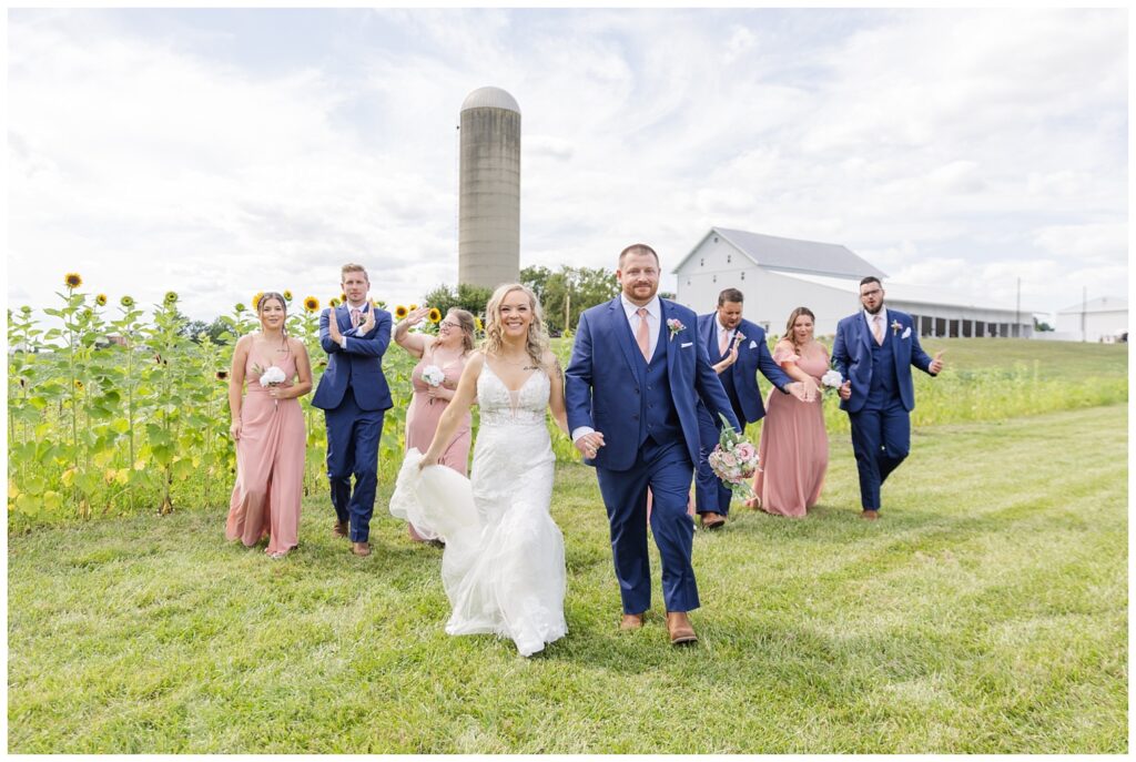 bride and groom walking in front of the bridal party at Arlington Acres