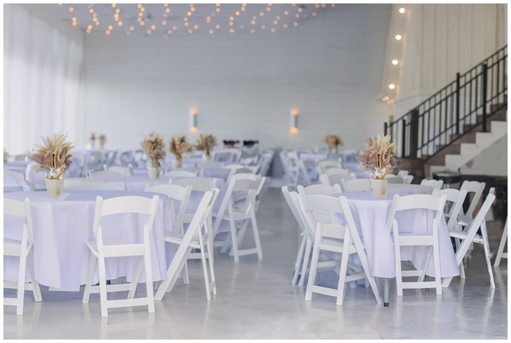 reception room decorated with white tables and centerpieces in Tiffin, Ohio