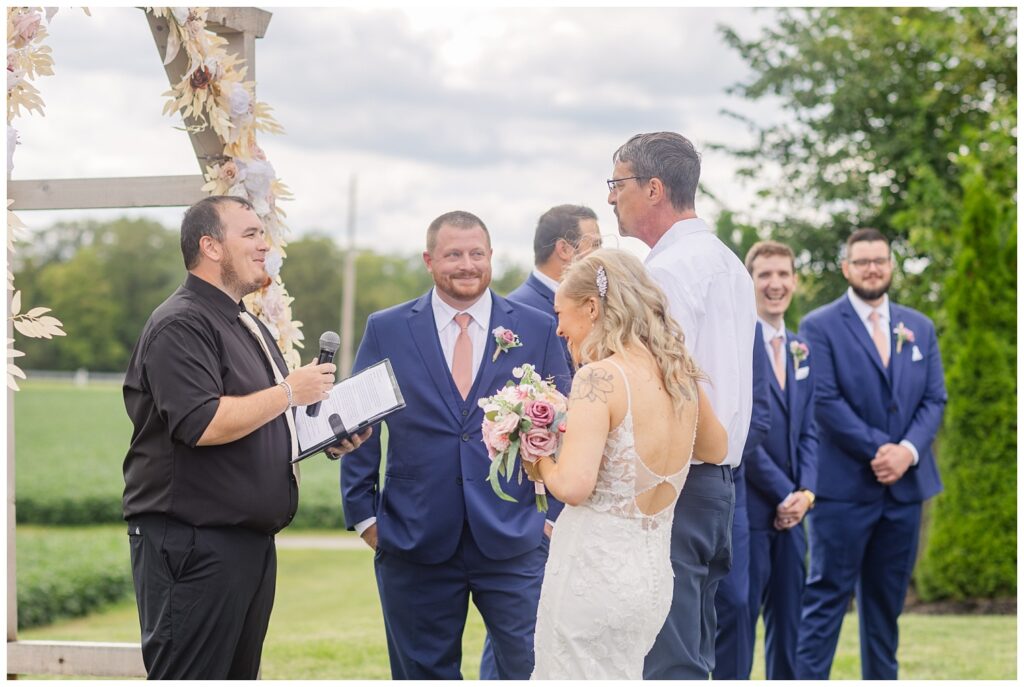 bride's dad giving away his daughter at the wedding ceremony in Tiffin, Ohio