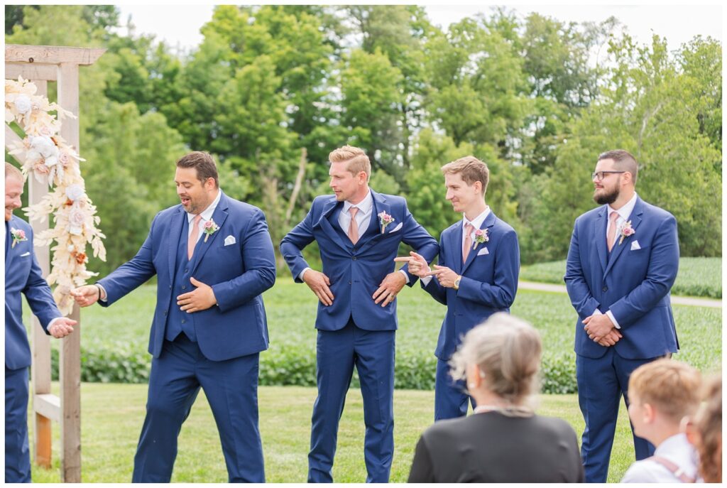 the groomsmen passing the ring to the groom during the wedding ceremony