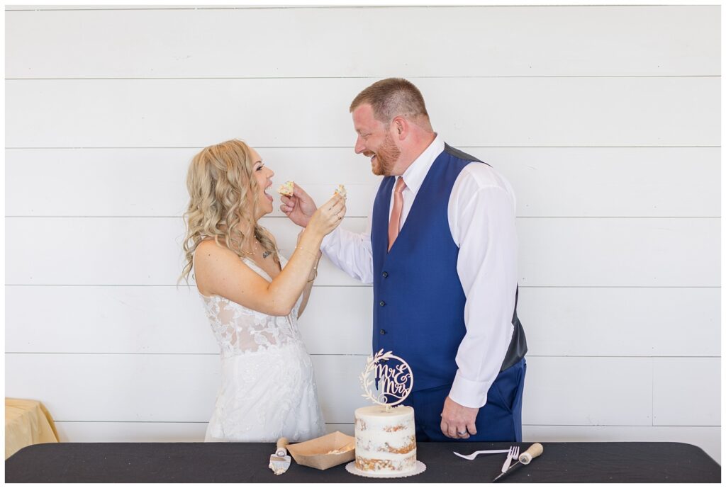 bride and groom feeding each other cake at Tiffin, Ohio wedding reception