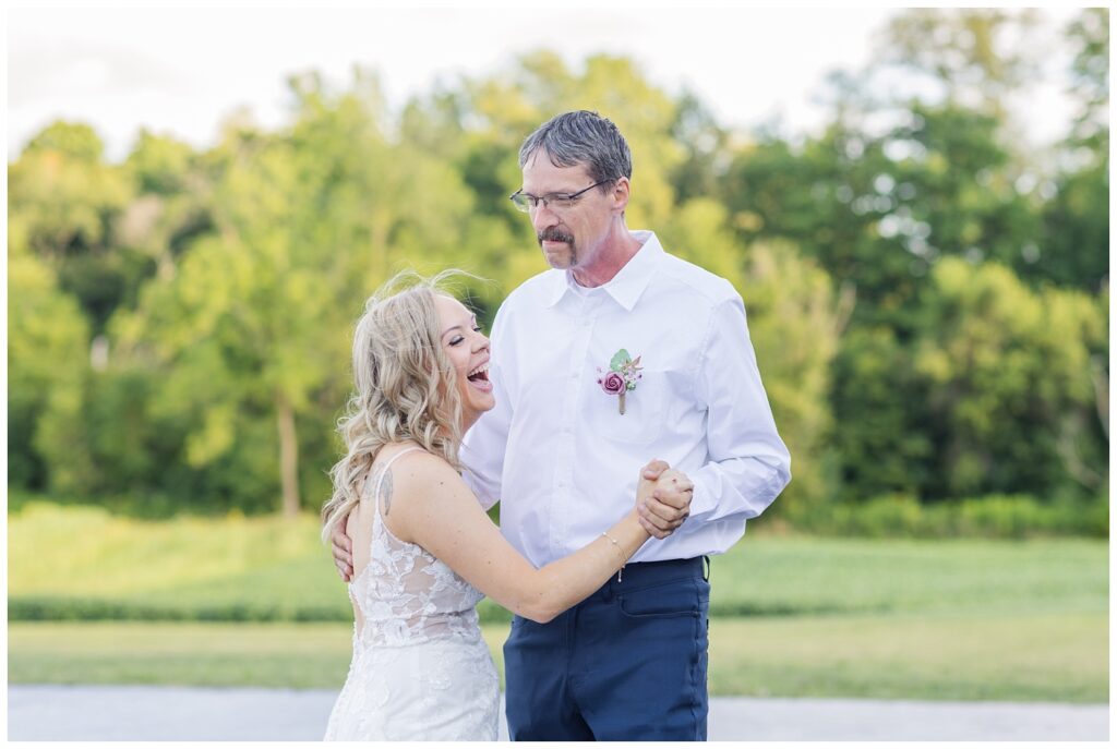 bride laughing while dancing with her dad at Tiffin, Ohio wedding reception