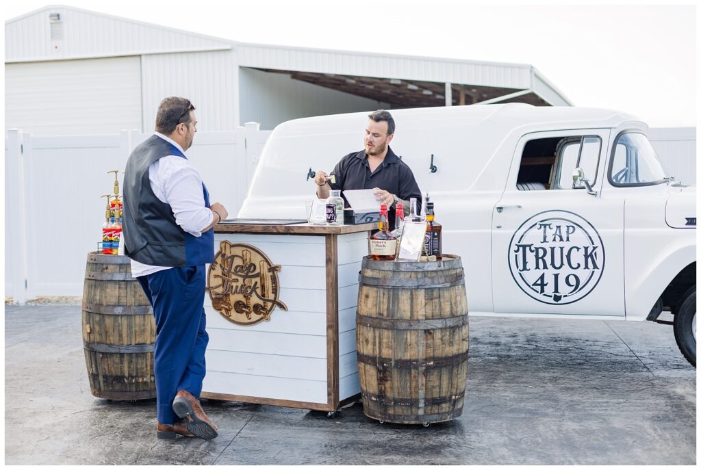 best man getting a drink from the mobile bartending company 