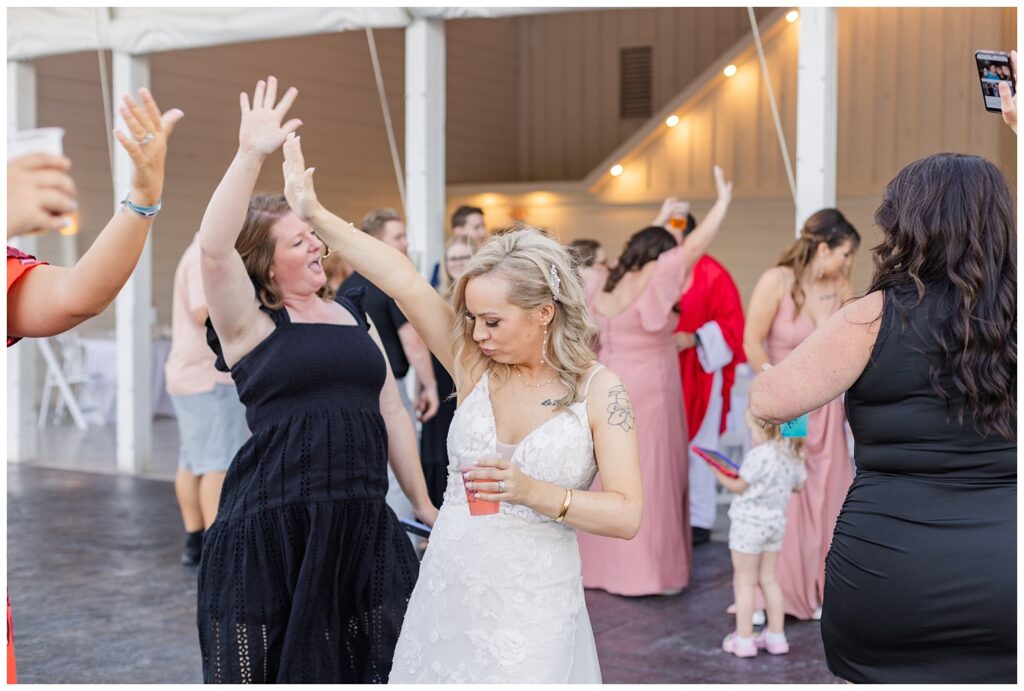 bride dancing with her friends outside at summer wedding in Tiffin, Ohio