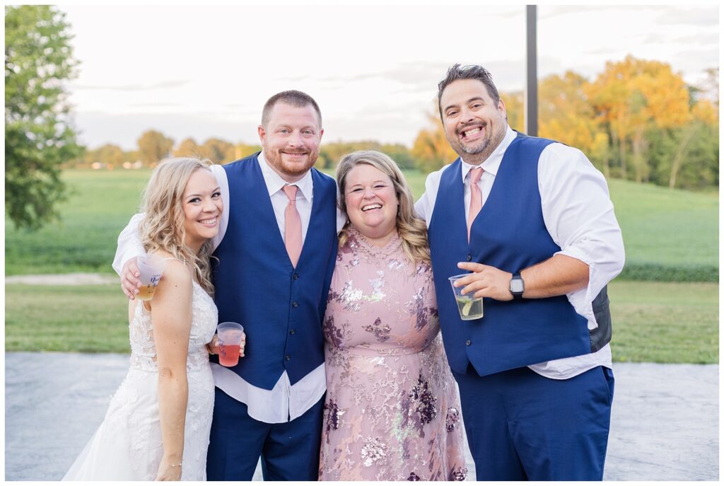 bride and groom posing with the best man and his wife at Arlington Acres