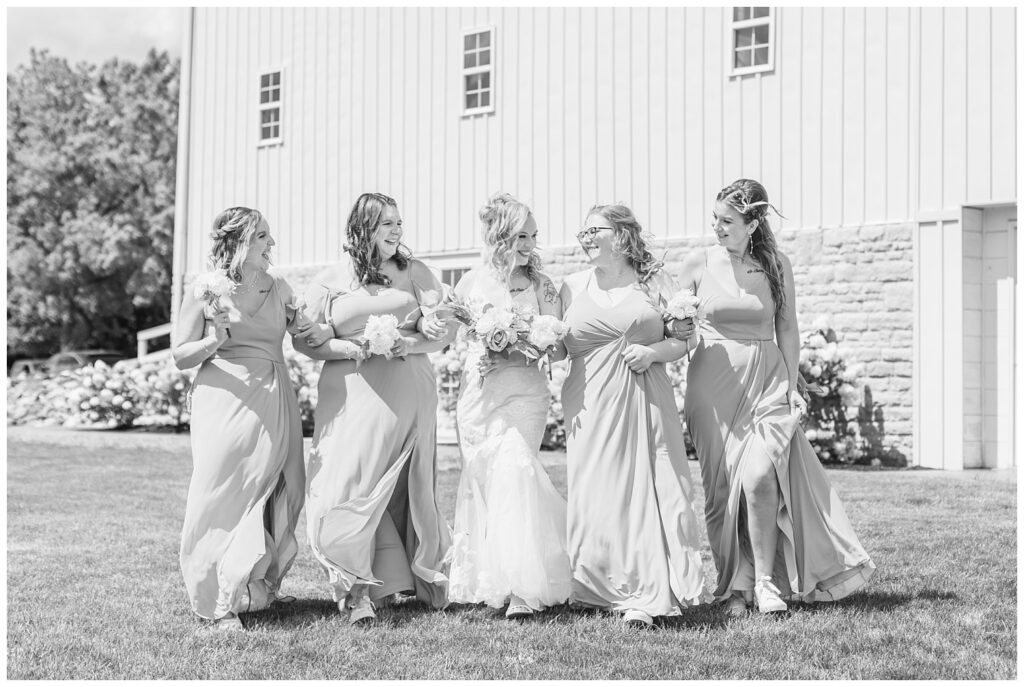 bridal party walking arm in arm outside the venue in Tiffin, Ohio