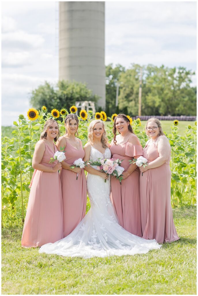 bridal party posing in front of the sunflowers in Tiffin, Ohio