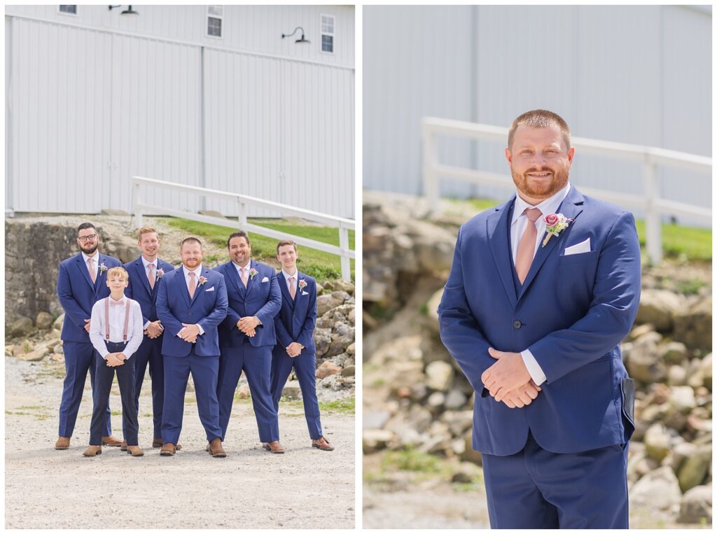 groom standing in front of a rock wall at Arlington Acres wedding venue