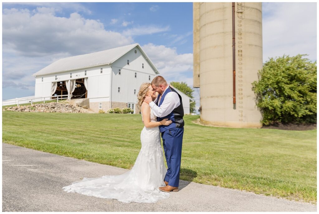 wedding couple standing on the road in front of a silo in Tiffin, Ohio