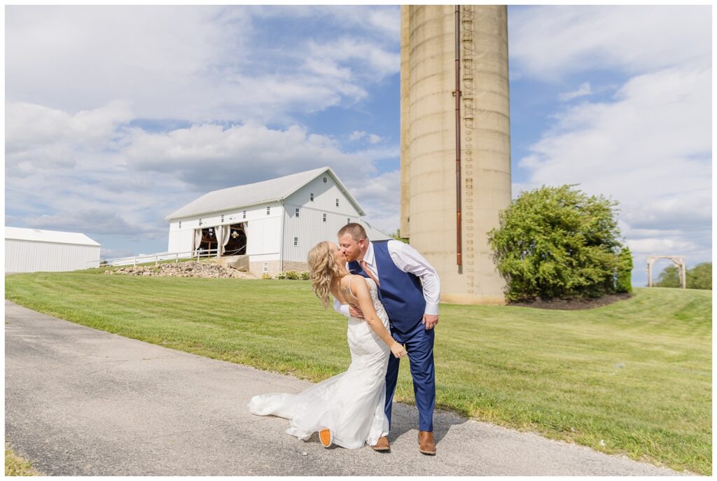 groom dipping the bride back for a kiss at Arlington Acres wedding venue