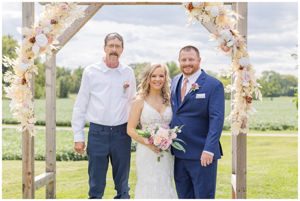 bride posing with her dad and husband at Tiffin, Ohio wedding venue