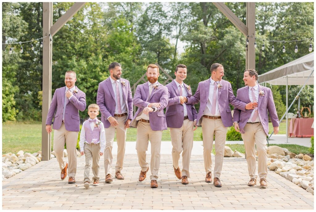 groomsmen walking together outside on the patio at the Homestead by Stillwaters