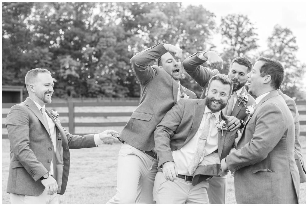 groomsmen being silly before the ceremony at Findlay, Ohio wedding venue