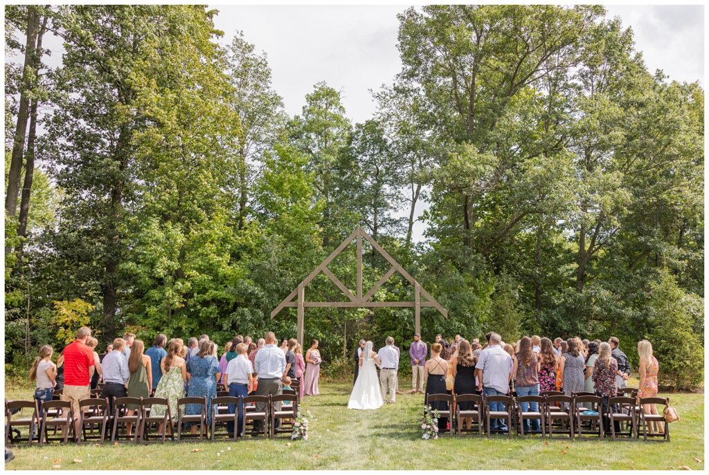 wide shot of the ceremony site outside under a wooden arch in Findlay, Ohio