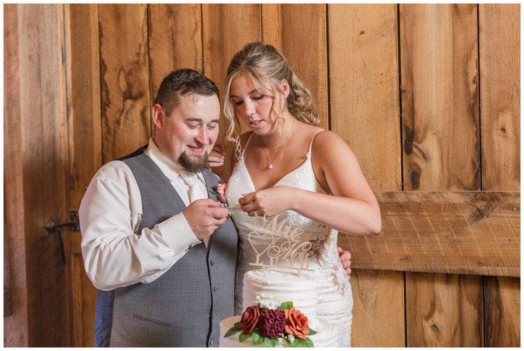 bride and groom cutting their wedding cake at Huron County Fairgrounds reception