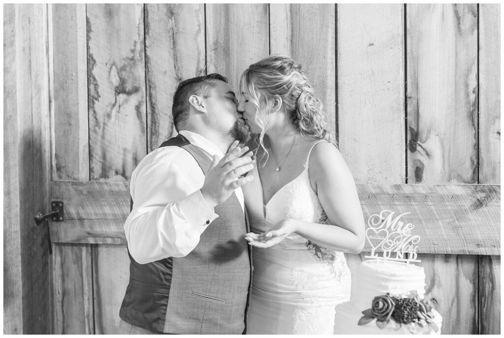 wedding couple share kiss after cutting their cake in Norwalk, Ohio