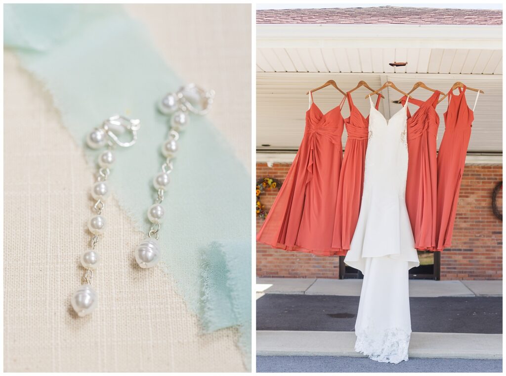 bride's wedding dress and bridesmaids dresses hanging together from the ceiling outside 