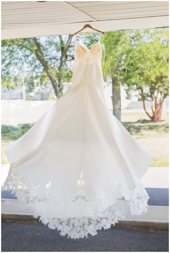 bride's wedding dress hanging from the outside area of the church in Ohio