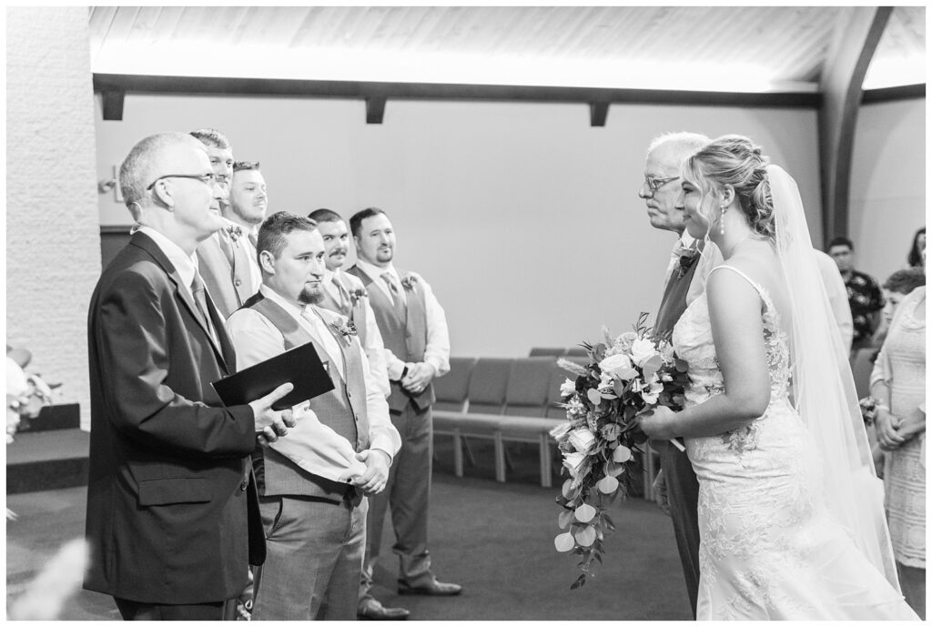 bride and the groom at the altar of the church