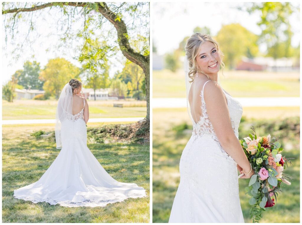 bride showing off the back of  her lace dress while holding her bouquet