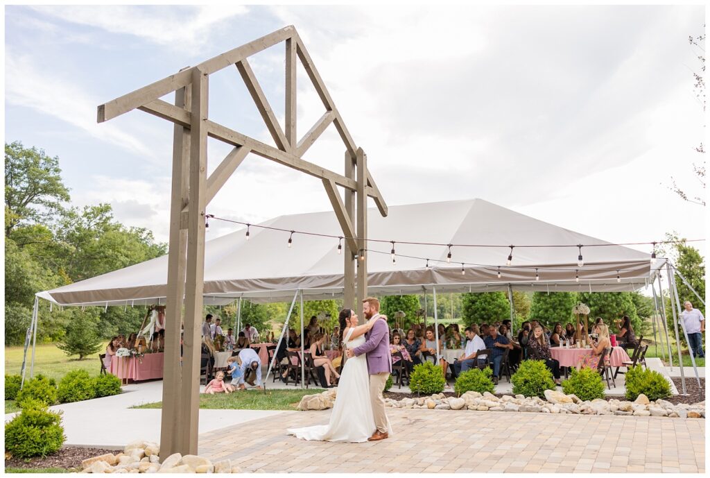 wedding couple share first dance on stone patio at the Homestead by Stillwaters