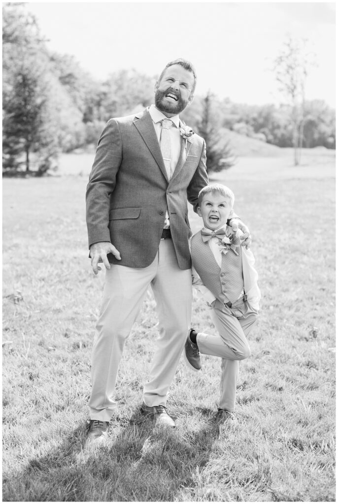 groom and bride's son being goofy during family portraits at wedding venue