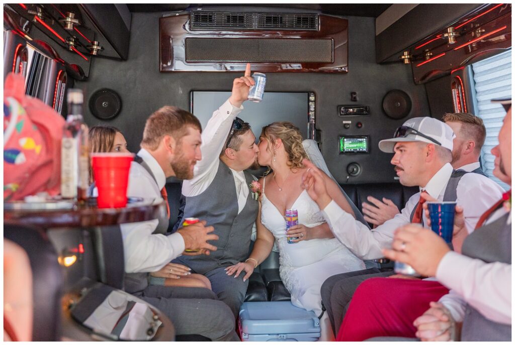 full wedding party going to the reception in a large party bus 