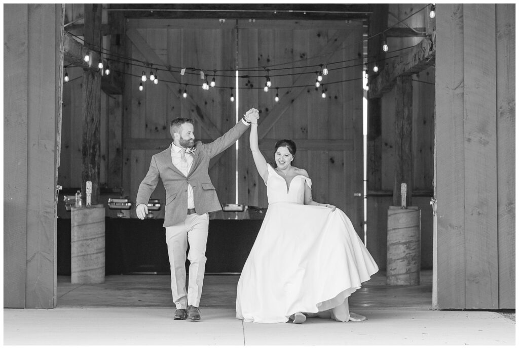 wedding couple walking out of reception venue holding hands for introduction