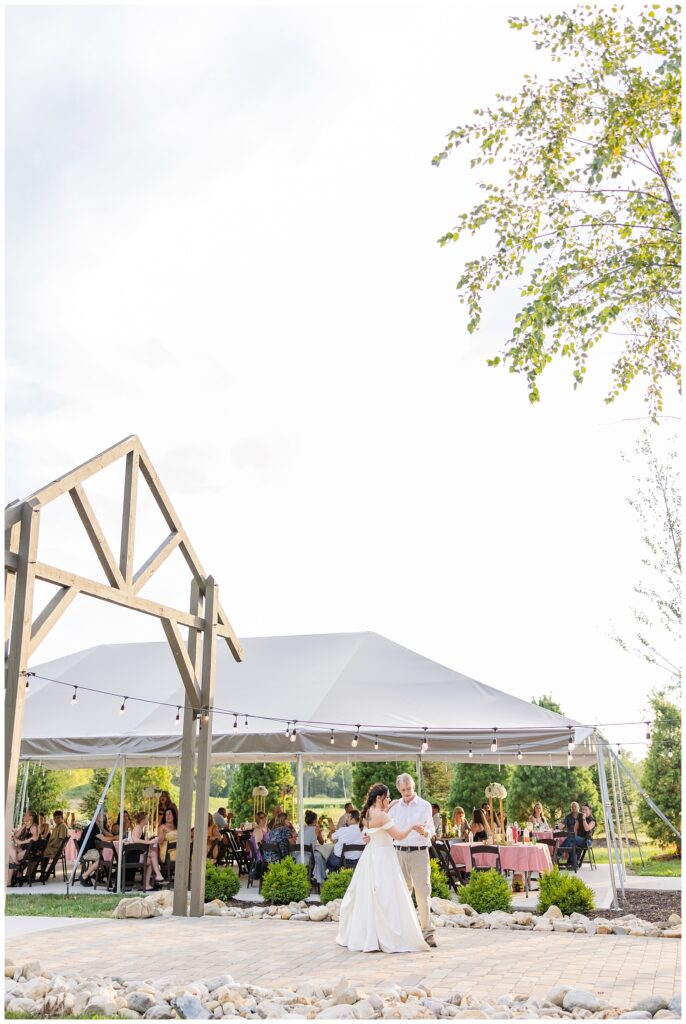 bride dancing with her dad on the stone patio at Findlay, Ohio wedding reception