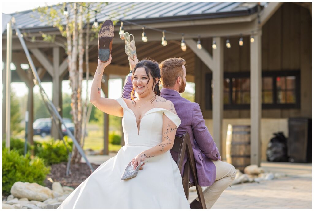 bride and groom participating in the shoe game on the outdoor patio during reception