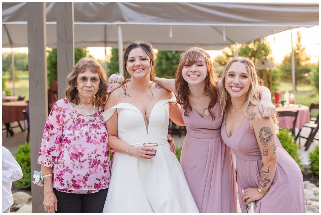 bride posing with family during wedding reception by Findlay, Ohio photographer