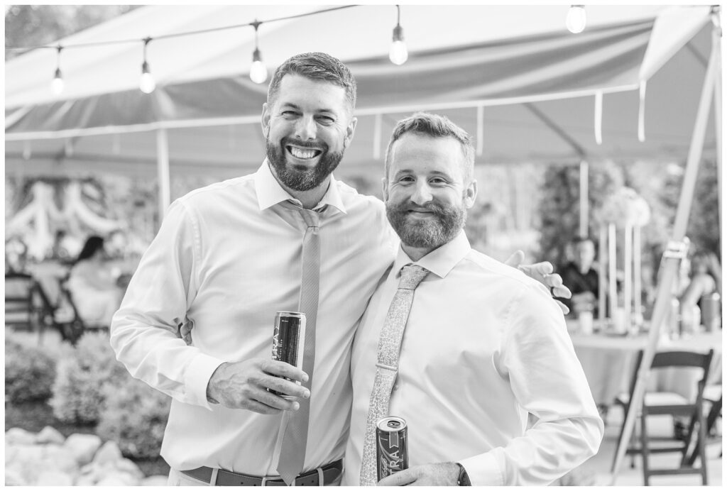 groom posing with his best man during the wedding reception outside in Findlay, Ohio