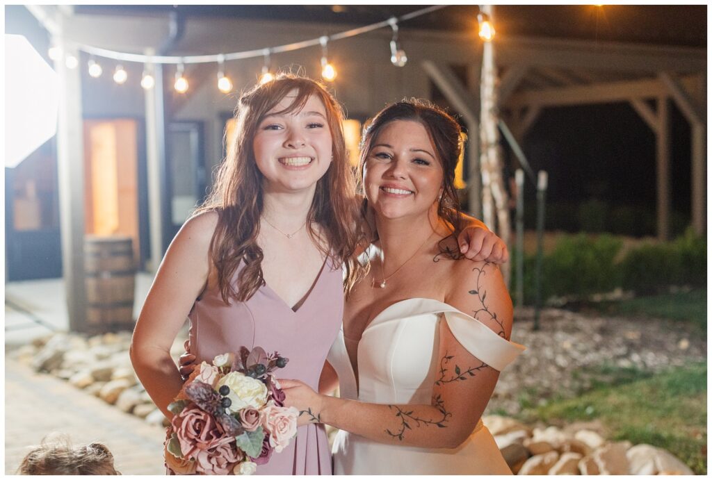 bride posing with the girl who caught her bouquet at Findlay, Ohio wedding reception