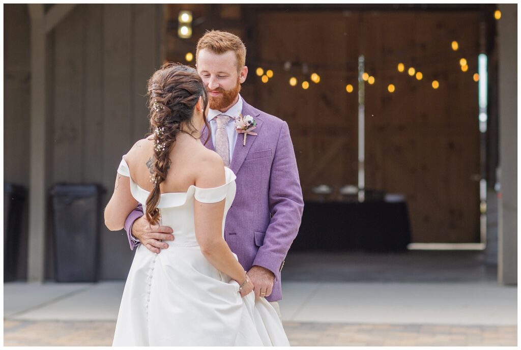 groom looking at the bride while they share a first dance as husband and wife