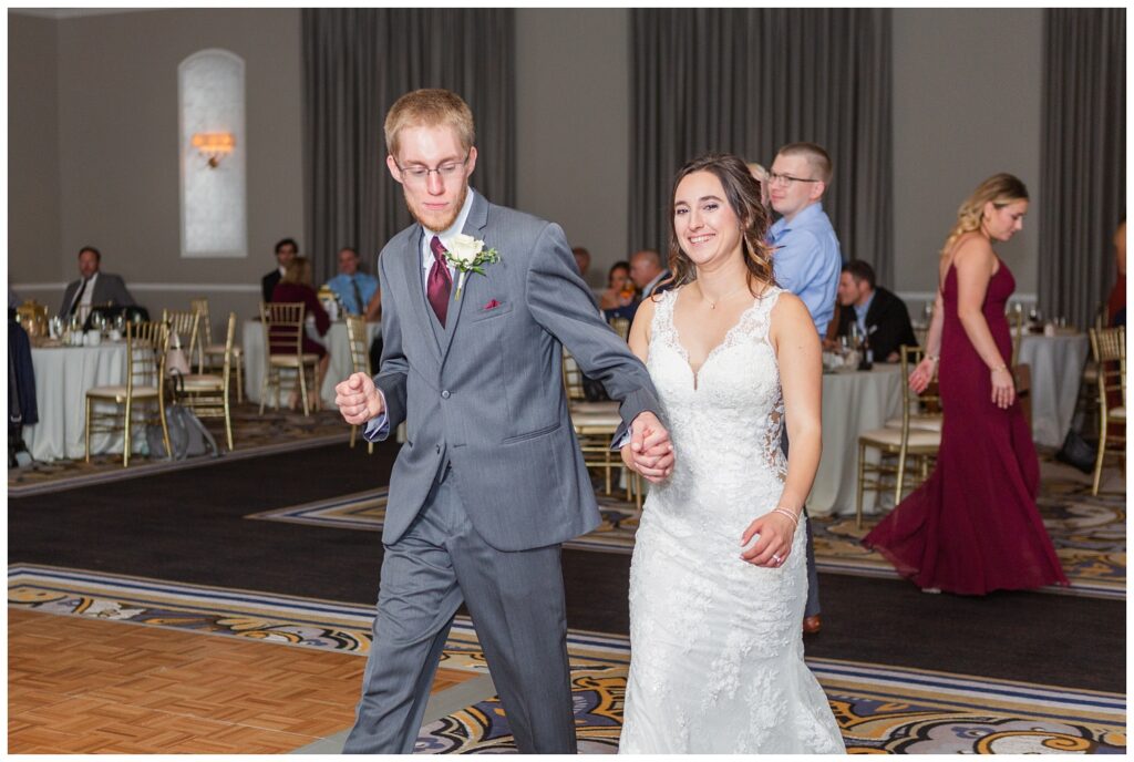 bride and groom dancing with their wedding guests at the hotel reception