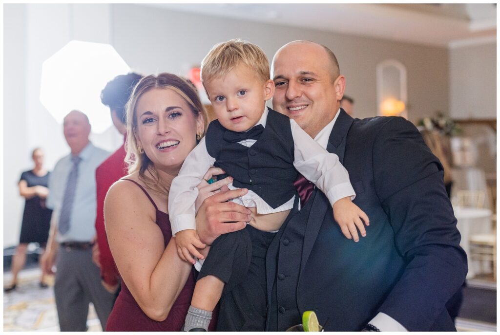 wedding guests holding up their son on the dance floor in Findlay, Ohio