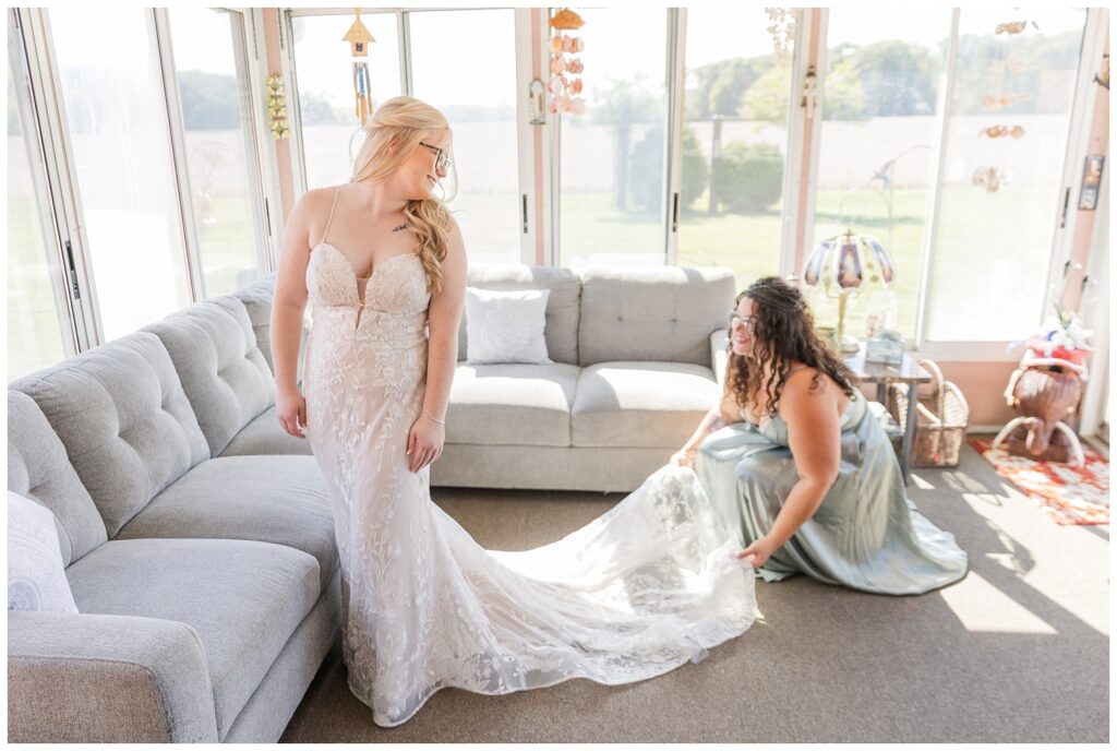 bridesmaid fluffing out the bride's wedding dress in Fostoria, Ohio