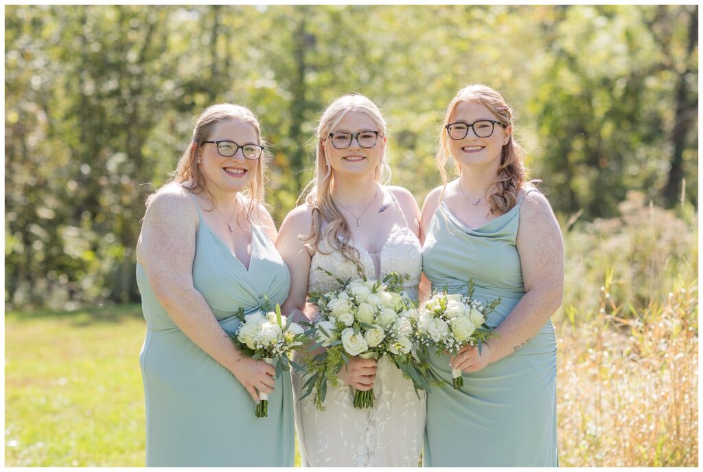 bride posing with her sisters at Bradner Preserve